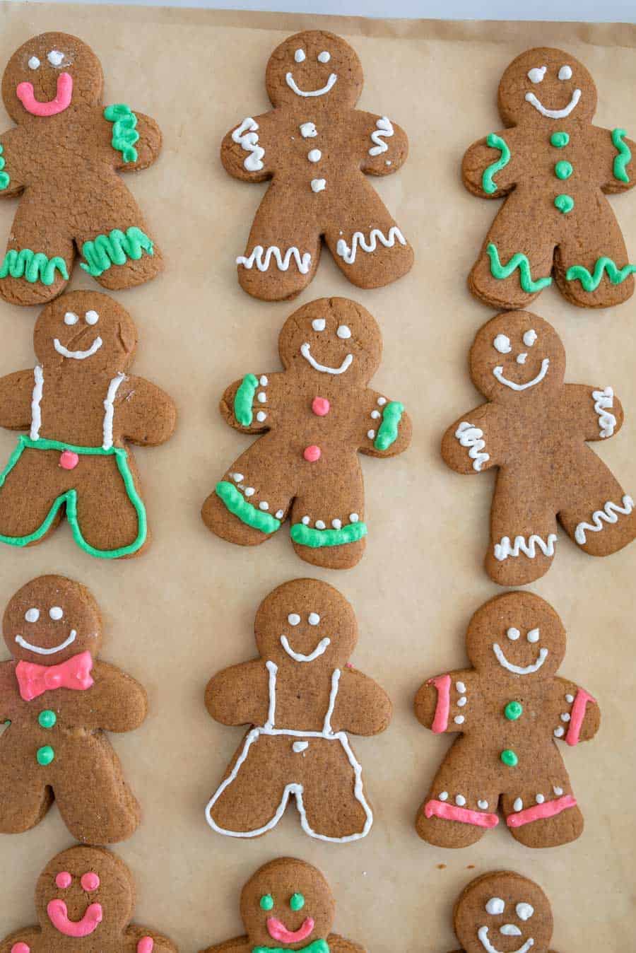 top view of traditionally decorated holiday ginger-people cookies on a sheet pan