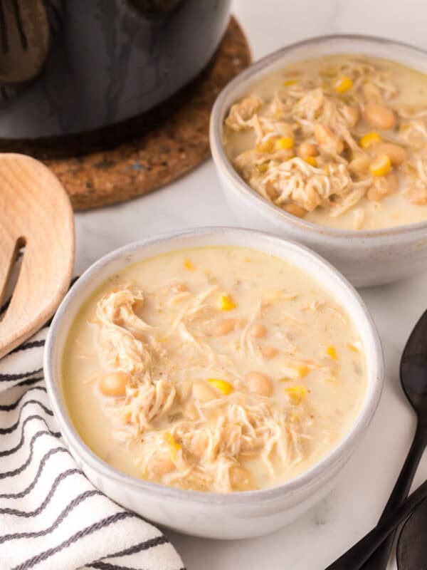 white chicken chili in white serving bowls.